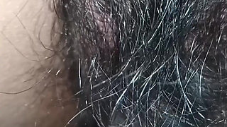 Close up view on a hairy and creamy pussy