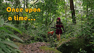 Little Red Riding Hood walking alone in the forest
