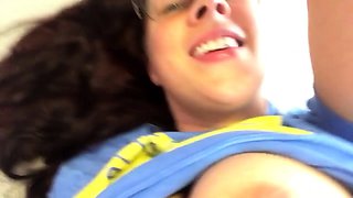 In a kitchen a sexy brunette playing with her big boobs