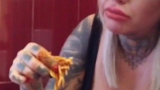 Blonde tattooed milf eats spaghetti on the toilet