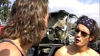 Short-haired German babe getting fucked by two hard cocks at the car waste