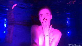 Beautiful brunette Lily swims alone in the pool and shows her natural beauty.