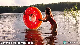 Margo Von Teese and Simona splash each other in their bikinis in a lake before eating each other out on the beach.