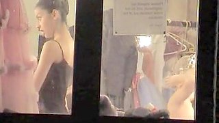Almost naked dancers filmed through the window