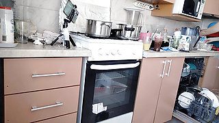 Sexy Latina nude in the kitchen. Sexy naked wife prepares food in the kitchen.