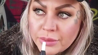 Blonde lady smokes an electronic cigarette