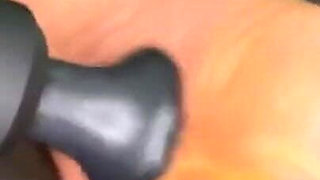 Ebony Girl Gives Her Feet a Massage with a Massage Gun