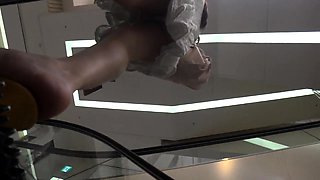 Slender Japanese teen with lovely ass upskirt in the store