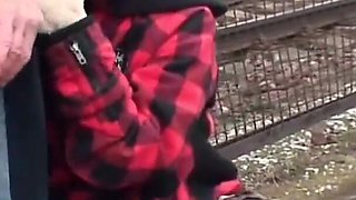 Brunette fucking with old dude next to a railway