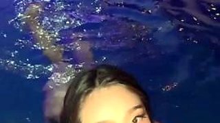 Exotic bombshell performs sensual striptease in the pool