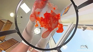 My Nylon Feet Squeezing Strawberry Juice on a Glass Table
