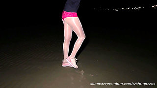 Anna in white shiny pantyhose on the night beach