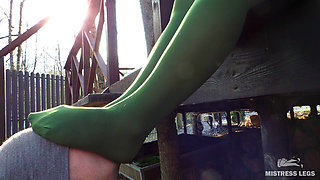 My nylon feet in green tights on your face