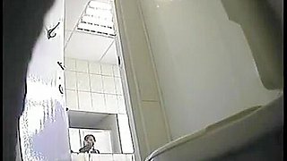A juicy brunette caught by a pissing in a public toilet
