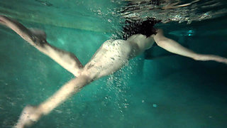 redhead girl swimming naked in pool