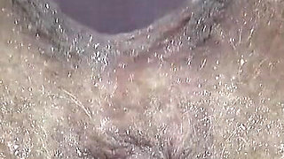 Extreme Close-up of Wet Hairy Vagina with Dildo