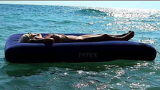 I Watched on the Beach How a Naked Girl with Big Tits Was Sunbathing on a Mattress. Slow Motion