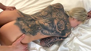 A blonde with big boobs fucks in reverse cowgirl on the bed