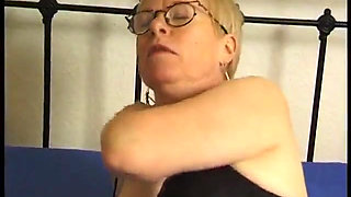 Mature caressing her body on the bed