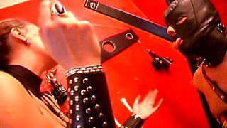 Two Mistresses Playing with Their Slave in the BDSM Dungeon