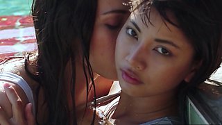 Asian lesbian teens playing in the pool