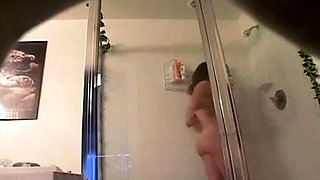 Kinky voyeur captures a desirable brunette taking a shower