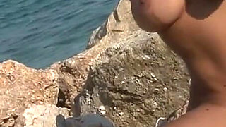 Seductive Brunette Babe Strips Naked on Rocky Beach