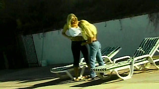 Petite blonde lesbians having fun by the pool