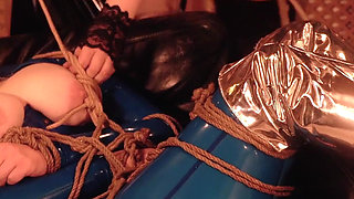 Bondage process: latex mistress and rubber submissive with gag and wet pussy