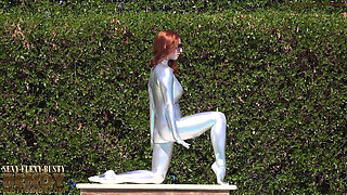 Bending in a Silver Spandex Suit