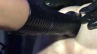 Lady Valeska and Miss Patricia have their sub over a bench.