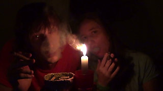 Couple Smoke Next to Candle