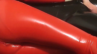 Hot MILF in a Red Latex Catsuit She Is Enjoying It with a Locked Slave. Second Angle