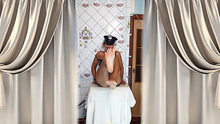 An elderly lady in the kitchen wearing an attractive suit
