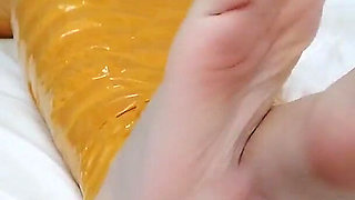 First-person Perspective Records the Girlfriend Wrapped in Tape From Head to Toe with Her Beautiful Bare Feet