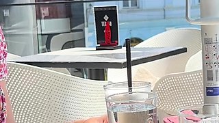 Cute girl reads a book in cafe with no bra with her nipple