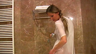 Busty blonde wearing shirt while taking a shower