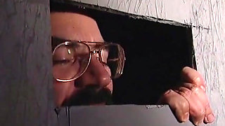 Blonde milf plays with two cocks at glory hole