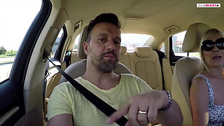 First hands on the steering wheel then mouth on the cock