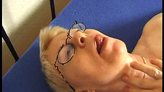 Mature caressing her body on the bed