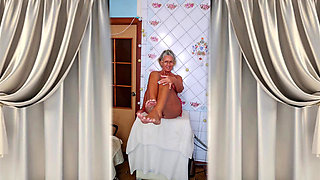 Hot housewife Lukerya at home in the kitchen.