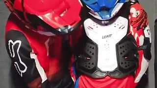 A Guy in a Motocross Gear Gets a Portion on His Mxhelmet