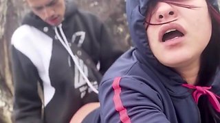 Hooded beauty sucks and rides young guy hard on rocky beach