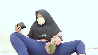 Indonesian hijab aunt wearing cucumber