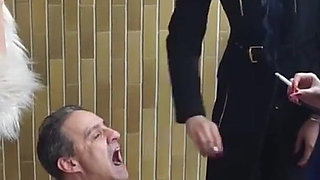 Fur-clad Femdoms Dominate Submissive on Balcony