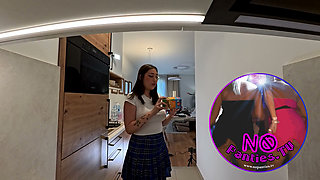 Hot sexy brunette babe in school uniform plaid skirt and black stockings in the kitchen
