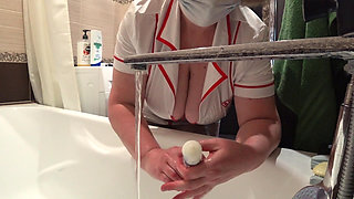 Big Boobs. Gorgeous Cleavage Under a Medical Gown. a Mature Nurse on Camera at Work