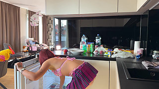 Real college girl in summer house prepares some fruits in the kitchen in the smallest bikini ever with a short skirt